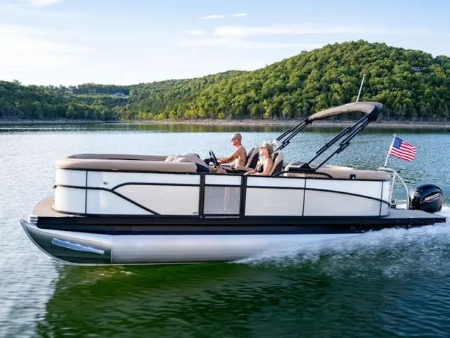 Slide: The Image of 2024 Barletta Corsa 21QC pontoon boat cruising on a scenic lake. - 1