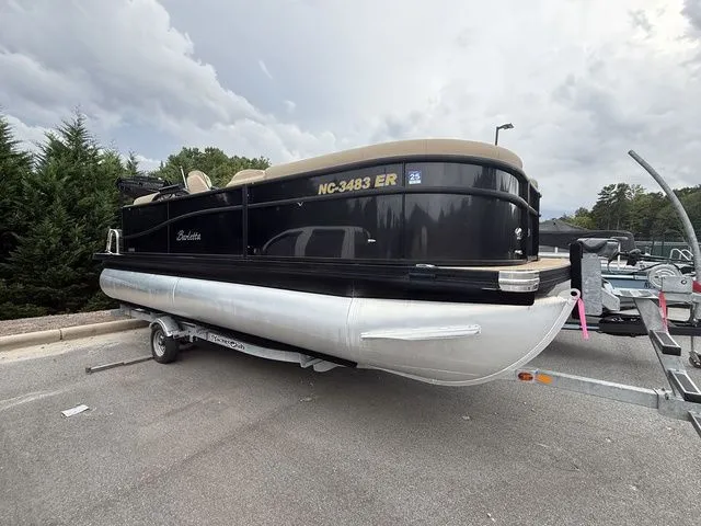 The Image of 2020 Barletta Boats C20Q pontoon on trailer, parked outdoors under cloudy sky. - 1