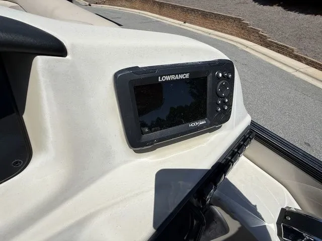 Slide: The Image of Lowrance fish finder on 2021 Barletta Boats C24Q dashboard, outdoor setting. - 12