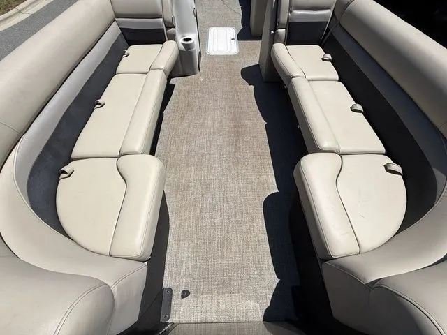 Slide: The Image of Interior seating of 2021 Barletta Boats C24Q, featuring beige upholstery and spacious layout. - 5