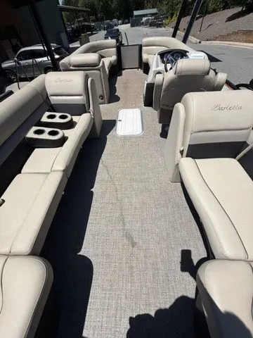 Slide: The Image of 2021 Barletta C24Q boat interior with beige seating and cup holders. - 9