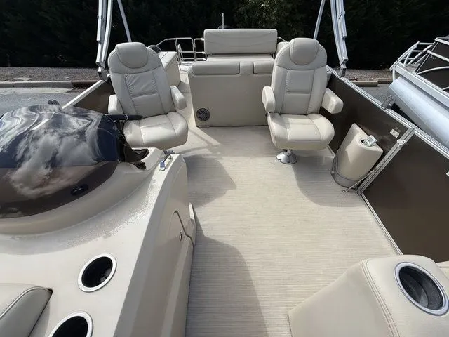 Slide: The Image of 2017 Sylvan 8524 DLZ LE pontoon boat interior with beige seating and helm. - 10
