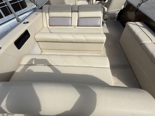 Slide: The Image of 2017 Sylvan 8524 DLZ LE boat interior with beige seating and shadow. - 5