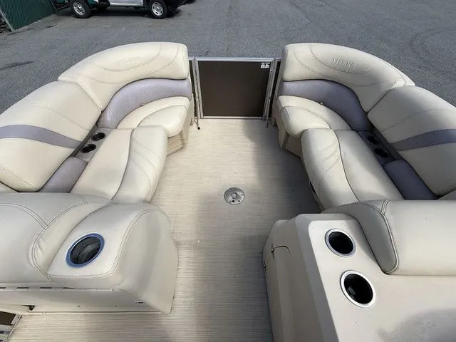 Slide: The Image of 2017 Sylvan 8524 DLZ LE pontoon boat with beige seating and cup holders. - 8