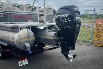 Slide: The Image of 2015 Sun Tracker PARTY BARGE® 24 XP3 with Mercury 200 outboard motor, parked on trailer. - 10