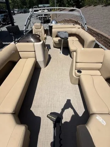 Slide: The Image of 2016 Bennington 22 SSX pontoon boat with spacious beige seating and modern design. - 16
