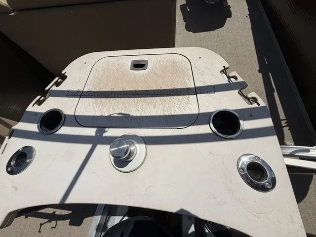 Slide: The Image of 2016 Bennington 22 SSX boat dashboard with cup holders and storage compartment. - 6