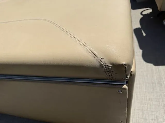 Slide: The Image of Torn beige upholstery on 2016 Bennington 22 SSX boat seat corner. - 8