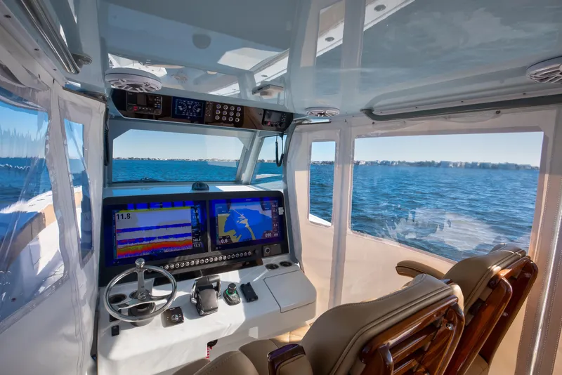 Slide: The Image of 2025 Freeman 43 Center Console interior with advanced navigation system on open water. - 12