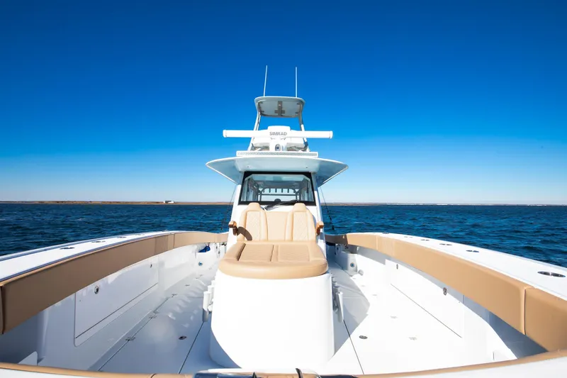 Slide: The Image of 2025 Freeman 43 Center Console boat on open water under clear blue sky. - 19