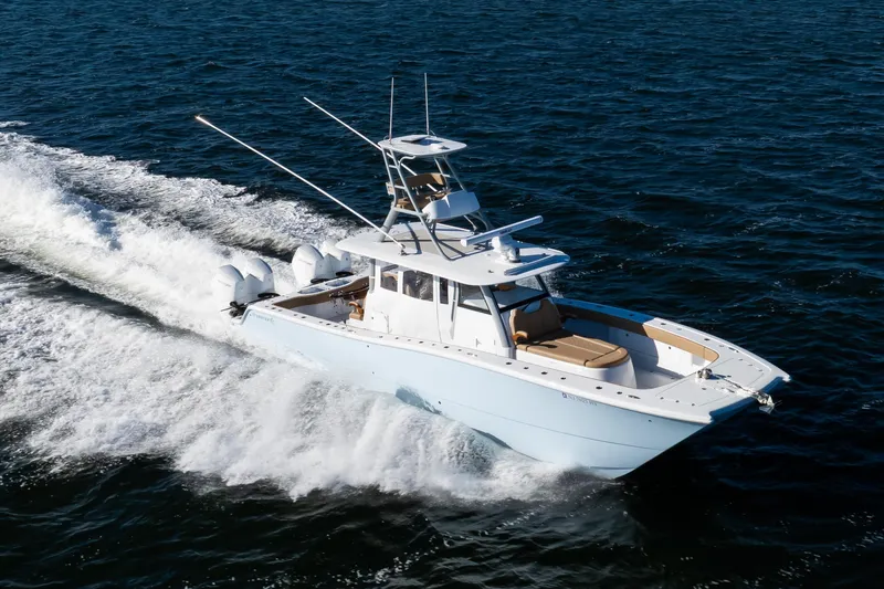 Slide: The Image of 2025 Freeman 43 Center Console boat cruising on open water. - 24