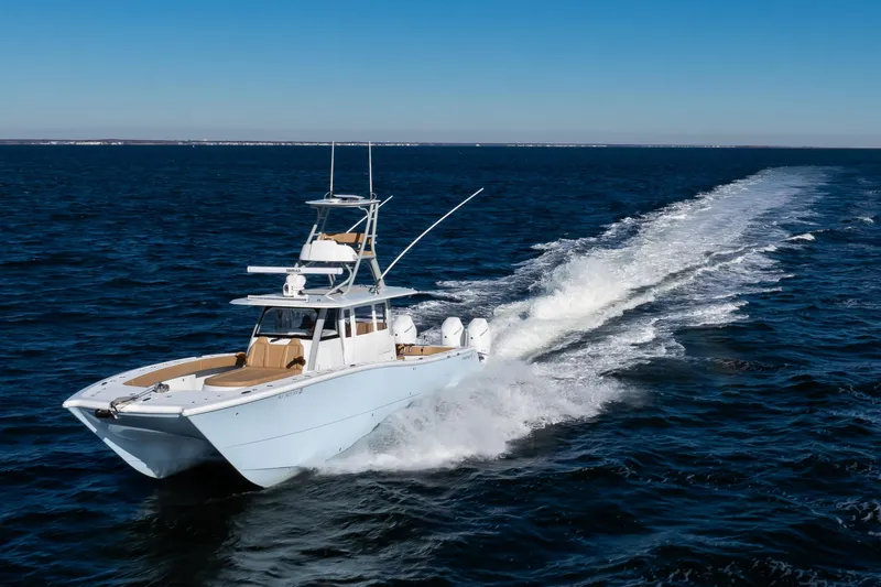 Slide: The Image of 2025 Freeman 43 Center Console boat cruising on open ocean waters. - 25