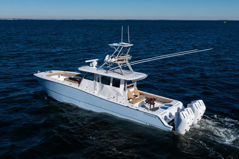 Slide: The Image of 2025 Freeman 43 Center Console boat cruising on open water. - 30