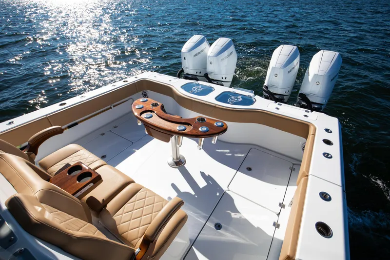 Slide: The Image of 2025 Freeman 43 Center Console boat with luxurious seating and powerful engines on open water. - 5