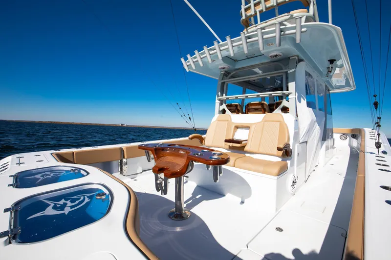 Slide: The Image of 2025 Freeman 43 Center Console boat with luxurious seating and fishing amenities on open water. - 6