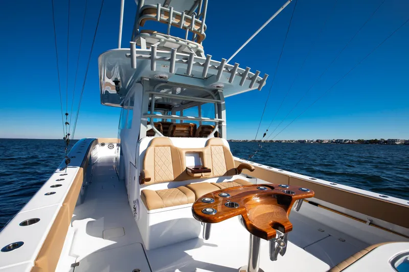 Slide: The Image of 2025 Freeman 43 Center Console boat on open water, featuring luxurious seating and fishing equipment. - 8