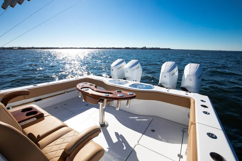 Slide: The Image of 2025 Freeman 43 Center Console boat on open water, featuring luxurious seating and powerful engines. - 9