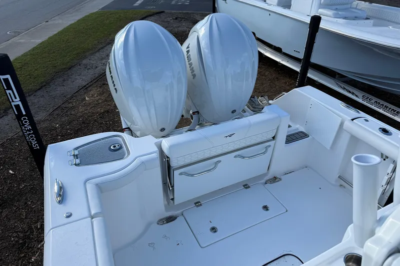 Slide: The Image of 2026 Tidewater 272 CC Adventure boat with dual Yamaha engines, docked at marina. - 10