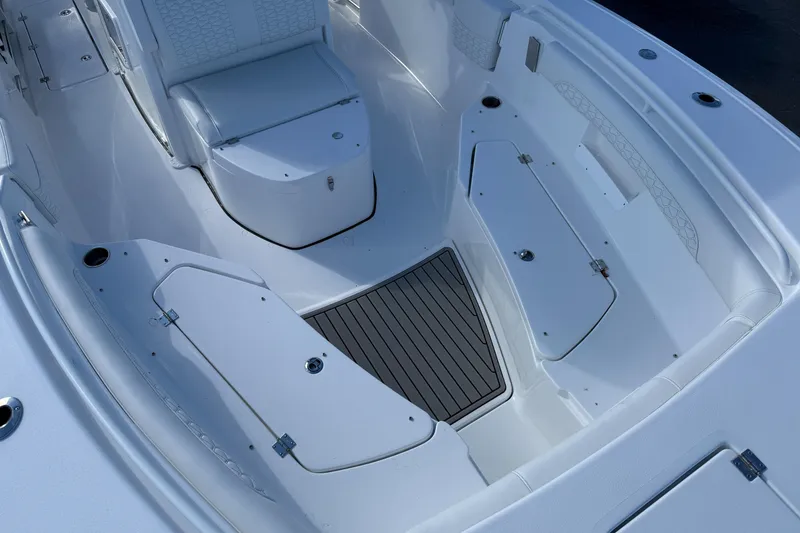 Slide: The Image of 2026 Tidewater 272 CC Adventure boat interior with seating and storage compartments. - 12