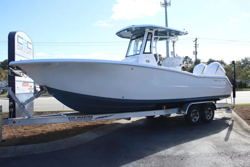 Slide: The Image of 2026 Tidewater 272 CC Adventure boat on trailer at dealership. - 13