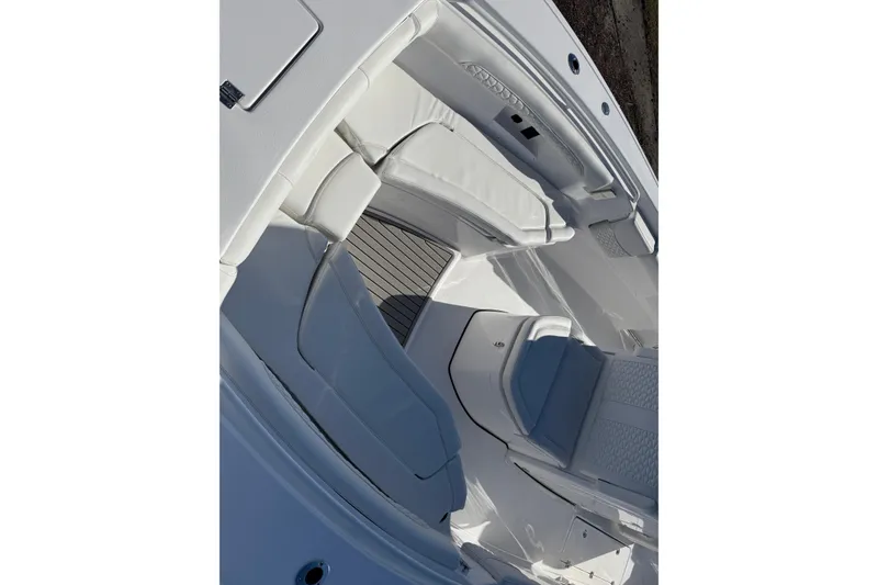 Slide: The Image of 2026 Tidewater 272 CC Adventure boat interior with white seating and sleek design. - 9