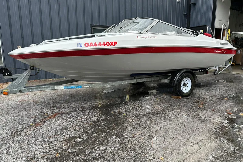Slide: The Image of 1991 Chris-Craft 167 Concept boat on trailer, white with red accents, parked outdoors. - 1