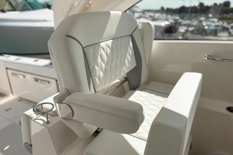 Slide: The Image of Luxurious seating on 2026 Pursuit DC 306 Dual Console boat, featuring elegant white upholstery. - 10