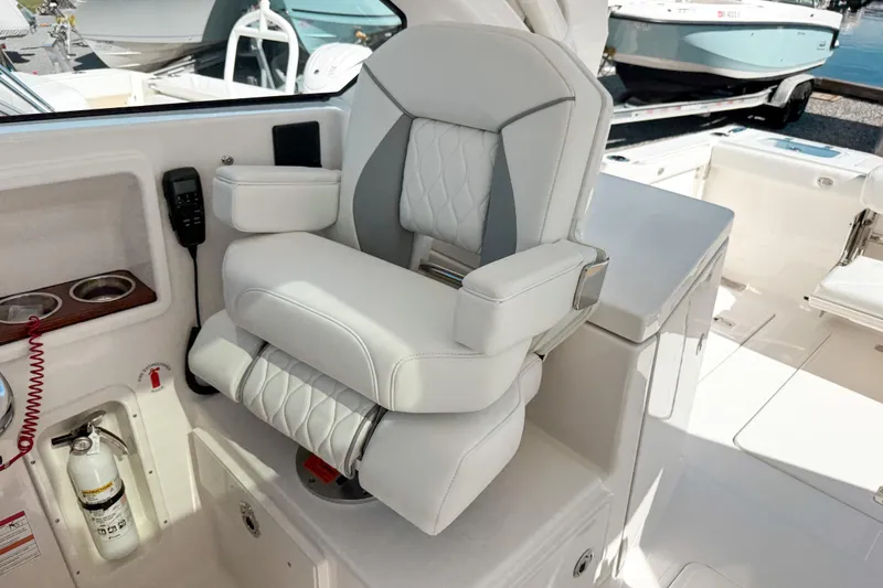 Slide: The Image of Luxurious seating on 2026 Pursuit DC 306 Dual Console boat, featuring elegant white upholstery. - 12