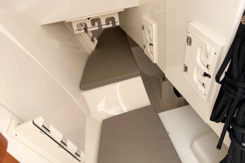Slide: The Image of Interior view of 2026 Pursuit DC 306 Dual Console boat, featuring storage compartments and seating. - 15
