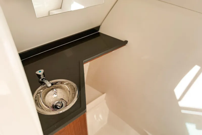Slide: The Image of 2026 Pursuit DC 306 Dual Console interior sink with modern design and sleek countertop. - 16