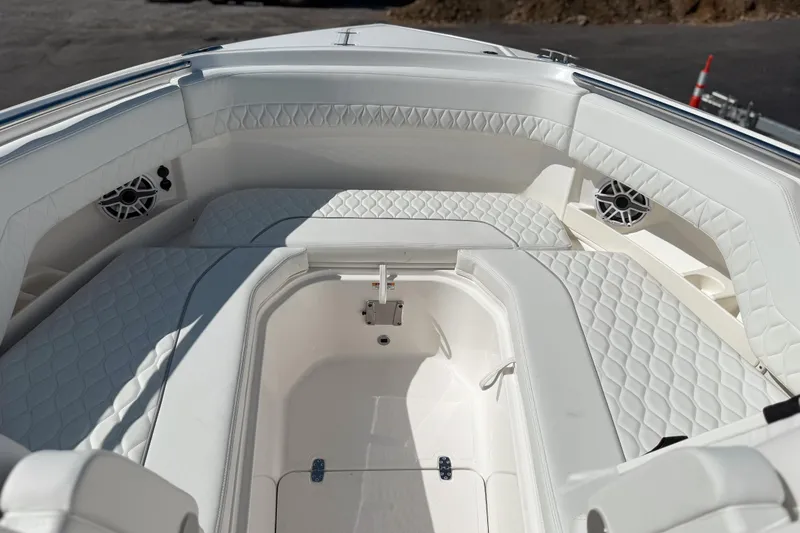 Slide: The Image of 2026 Pursuit DC 306 Dual Console boat interior with white quilted seating. - 18