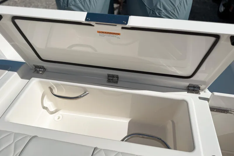 Slide: The Image of Open storage compartment on 2026 Pursuit DC 306 Dual Console boat. - 21