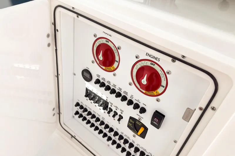 Slide: The Image of Control panel of 2026 Pursuit DC 306 Dual Console boat with switches and dials. - 24