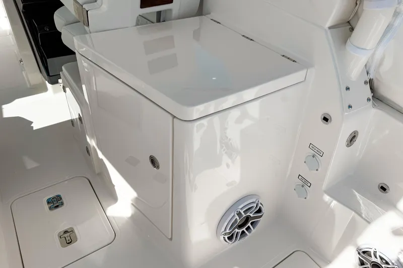 Slide: The Image of 2026 Pursuit DC 306 Dual Console boat interior with storage and control panel. - 3