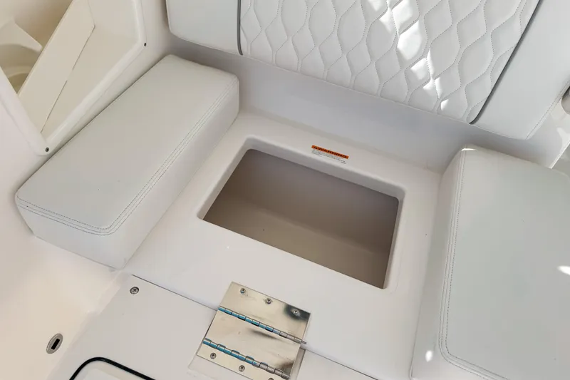 Slide: The Image of 2026 Pursuit DC 306 Dual Console interior seating with storage compartment. - 6