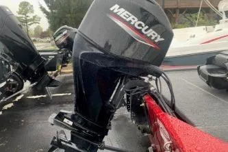 Slide: The Image of 2023 Tracker Bass Tracker Classic XL with Mercury outboard motor in a marina setting. - 2