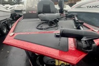 Slide: The Image of 2023 Tracker Bass Tracker Classic XL boat with red exterior, parked among other boats. - 3
