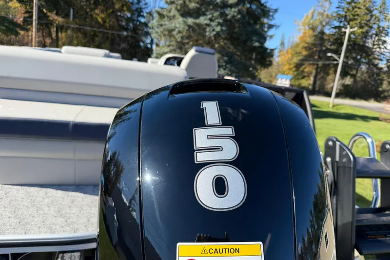Slide: The Image of Outboard motor on 2026 Berkshire 22 CL2 LE boat, sunny day, outdoor setting. - 10