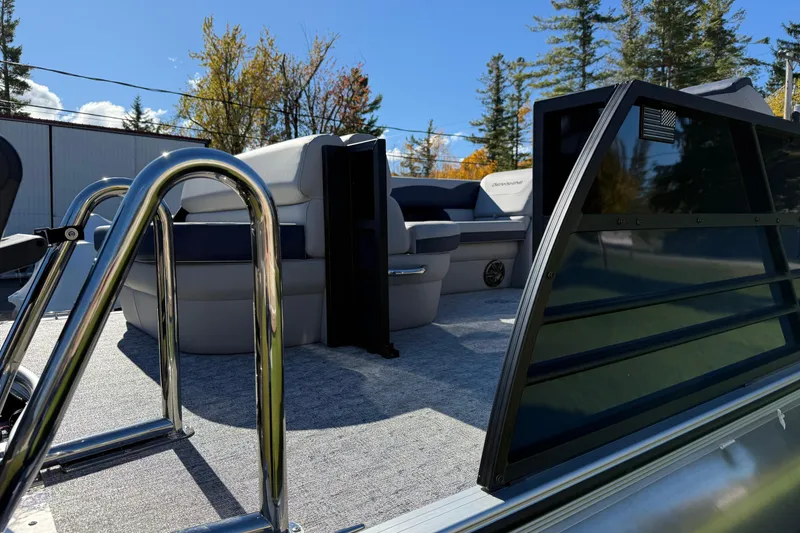 Slide: The Image of 2026 Berkshire 22 CL2 LE pontoon boat with seating, ladder, and railing under clear blue sky. - 2