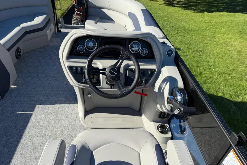 Slide: The Image of Cockpit of 2026 Berkshire 22 CL2 LE pontoon boat with modern steering and controls. - 6