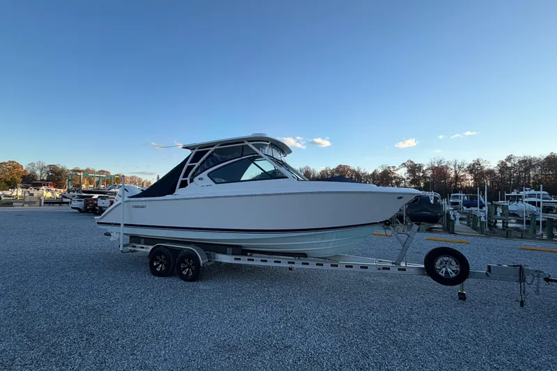 Slide: The Image of 2022 Pursuit DC 266 Dual Console boat on trailer at marina. - 24