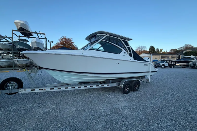 Slide: The Image of 2022 Pursuit DC 266 Dual Console boat on trailer in outdoor storage area. - 31