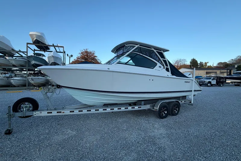 Slide: The Image of 2022 Pursuit DC 266 Dual Console boat on trailer in outdoor storage area. - 32