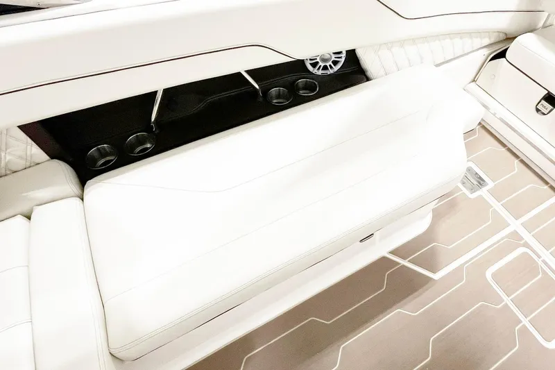 Slide: The Image of 2025 Regal LX6 boat interior with white seating and modern design elements. - 13
