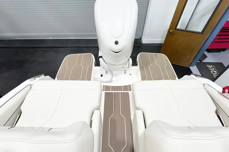 Slide: The Image of 2025 Regal LX6 boat interior with white seating and brown accents, showcasing modern design. - 15