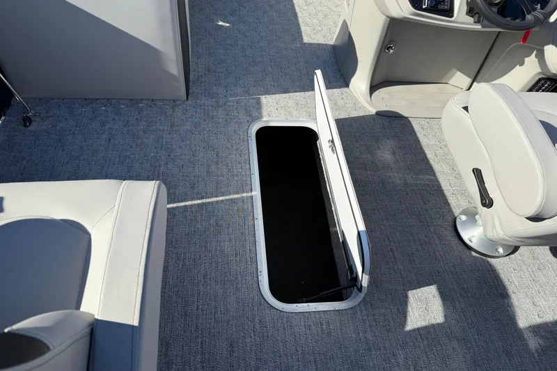 Slide: The Image of 2026 Berkshire 22 RFX LE boat interior with open storage compartment and seating. - 13