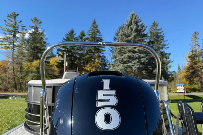 Slide: The Image of 2026 Berkshire 22 RFX LE boat with 150 horsepower engine, surrounded by trees. - 4