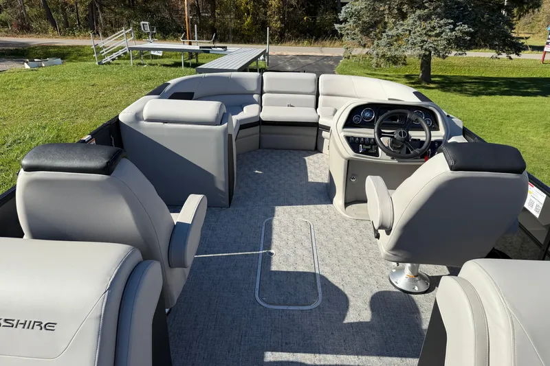 Slide: The Image of 2026 Berkshire 22 RFX LE pontoon boat interior with plush seating and modern helm. - 9