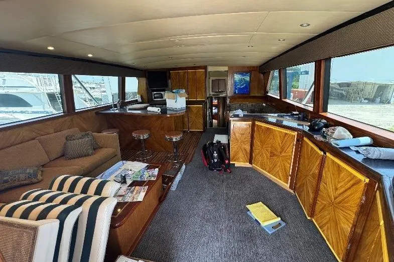 Slide: The Image of Luxurious interior of a 1994 Bertram 60 Convertible yacht with elegant wood finishes. - 11