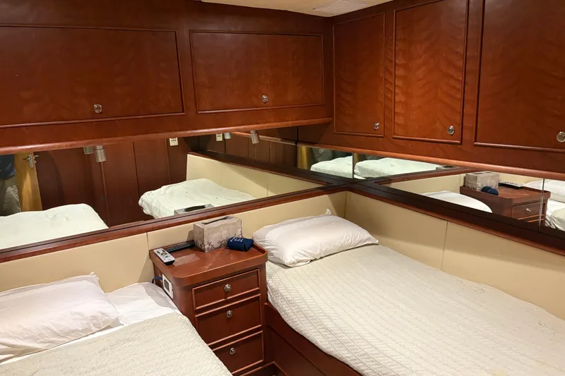 Slide: The Image of Luxurious cabin interior of 1994 Bertram 60 Convertible yacht with twin beds and wooden cabinetry. - 14